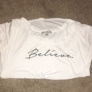 White thin t-shirt that says ‘believe’ in cursive